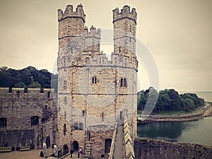 Caernarfon Castle is a medieval fortress in Caernarfon, Gwynedd, north-west Wales cared for by Cadw, the Welsh Government`s histor