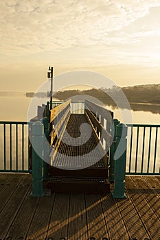 Caernarfon Pier reflected in the water in the morning sunlight