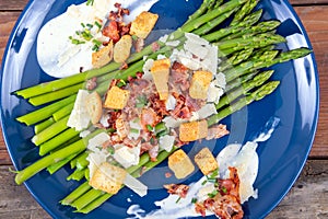 Caesar asparagus with sliced parmesan cheese bacon and crouton gourmet cuisine dish