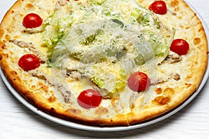 Caesar pizza decorated with sherry tomatoes close up