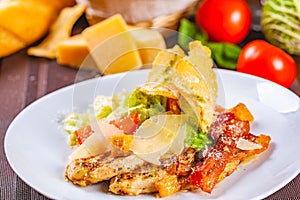 Caesar salad with bacon and chicken on white plate