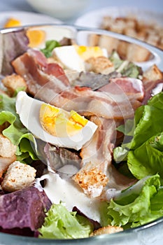 Caesar salad with bacon and eggs