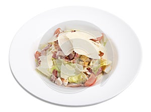 Caesar salad with bacon and parmesan in a white plate.