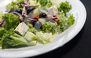 Caesar salad with chicken fillet and parmesan cheese, onion, olives, salad.