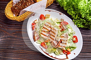 Caesar salad on dark wooden rustic background