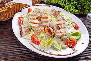 Caesar salad on dark wooden rustic background