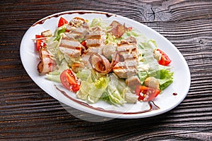 Caesar salad on dark wooden rustic background