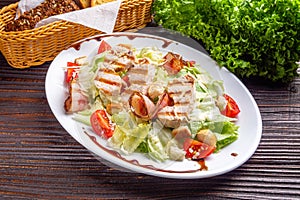 Caesar salad on dark wooden rustic background