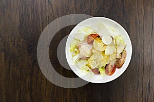 Caesar salad delicious healthy food tomatoes croutons Parmesan cheese and fresh mozzarella on wood background