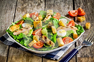 Caesar salad with grilled chicken, croutons, quail eggs and cherry tomatoes