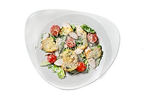Caesar salad with grilled chicken, croutons, quail eggs and cherry tomatoes. Isolated on white background. Top view.