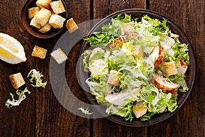 Caesar salad with grilled chicken meat, fresh lettuce, parmesan cheese and fried croutons. Classic North American cuisine