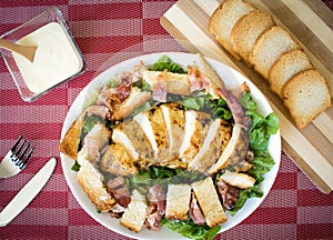 Caesar salad with grilled chicken parmesan cheese and toast photo