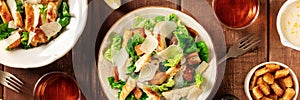 Caesar salad panoramic banner on a dark rustic wooden background
