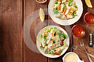 Caesar salad, shot from above on a dark rustic wooden background