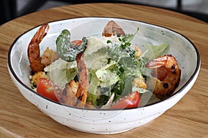 Caesar salad with shrimp. Caesar salad on a white background