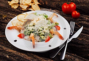 Caesar salad shrimps on white plate