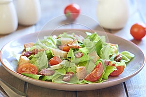 Caesar salad with smoked ham and cherry tomatoes