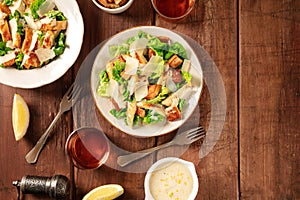 Caesar salad, top shot on a dark rustic wooden background