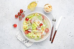 Caesar salad on white plate, top view