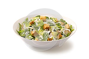 Caesar salad in a white plate photo