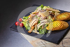 Caesars salad on black background photo