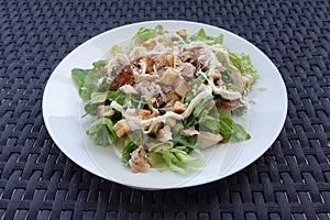 Caesars salad with grilled chicken lettuce and croutons photo