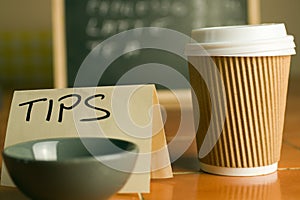 Cafe counter with coffee cup, prices and tip box photo