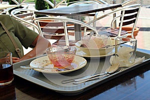 In the cafe after dinner, there is a tray with dirty dishes on the table.