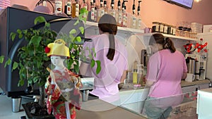 cafe with drinks preparation two girls in pink clothes prepare delicious Bubble Tea with balls cozy cafe coffee machine