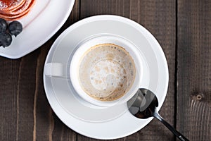 Cafe espresso macchiato layered coffee in a see through white glass coffee cup photo