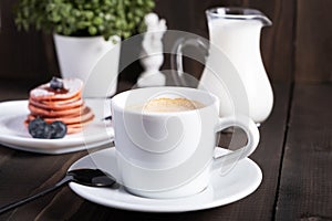 Cafe espresso macchiato layered coffee in a see through white glass coffee cup photo