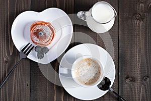 Cafe espresso macchiato layered coffee in a see through white glass coffee cup photo