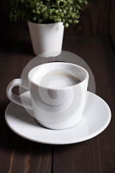 Cafe espresso macchiato layered coffee in a see through white glass coffee cup photo