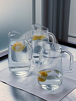 Cafe: glass water jugs with lemon photo