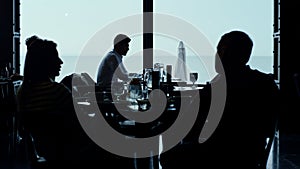 Cafe guests silhouettes resting panoramic lounge bar looking scenic seascape