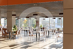Cafe Interior. Modern cafe interior with bright room with tables and chairs nobody, large windows, modern style