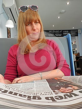 Cafe newspaper woman