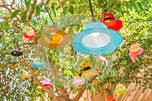 Cafe outside light decor closeup. Summer concept. Vacation, travel conceptual. New life for old hats, panamas