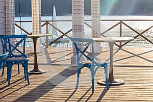 Cafe outside with wooden table and chair by the sea in the morning