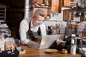 Cafe owner working on laptop