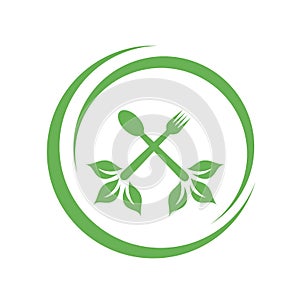 Cafe or restaurant serving Organic food logo- leaves from spoon and fork symbolizing Vegan friendly diet by European Vegetarian photo