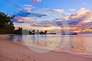 Cafe on Seychelles tropical beach at sunset