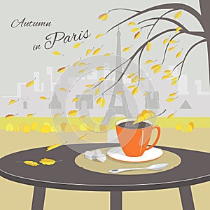 Cafe table with cup of coffee and Paris background