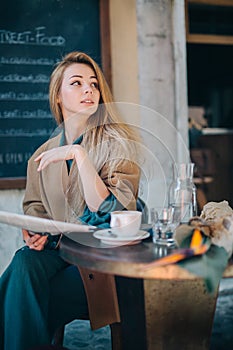 Cafe table customer young woman coffee cup newspaper lifestule