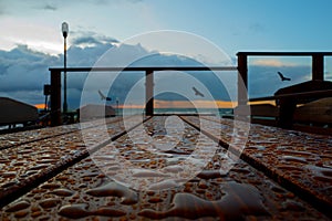 Cafe table in raindrops on background of the Baltic Sea