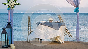 Cafe Table on a tropical sandy beach with sea on background, Nusa Dua, Bali