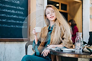 Cafe table young woman drinking coffee cup background lifestule