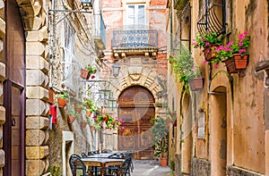 Cafe tables and chairs outside in old cozy street in the Positano town, Italy photo