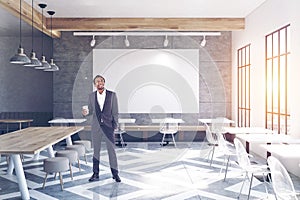 Cafe with tables, round chairs, big poster man